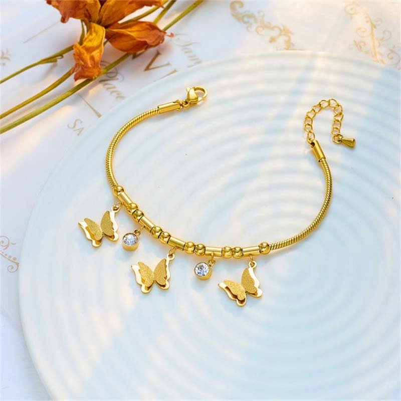 Second image of This is a gold butterfly pendant snake chain bracelet 